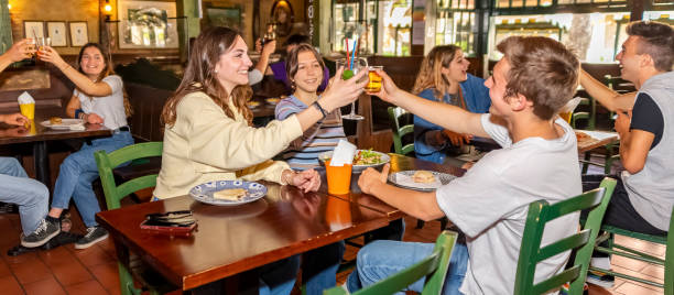 Group of millennials friends eating at fast
